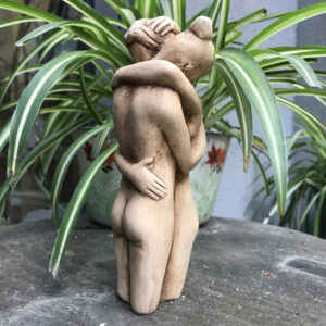 Lesbian couple hugging statue